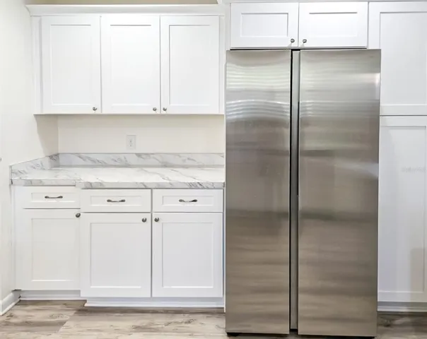 a view of an empty room with closet and mirror