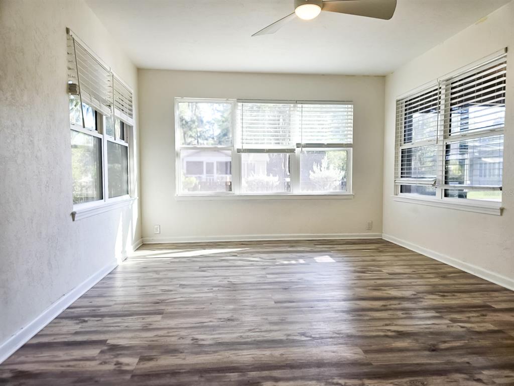 518 Northwest 27th Avenue Gainesville, FL 32609 - Photo 19 of 34 a view of an empty room with wooden floor and a window