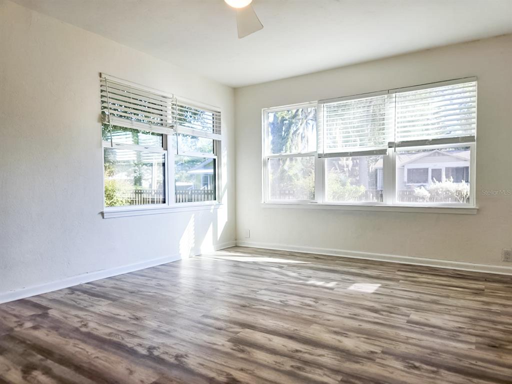 518 Northwest 27th Avenue Gainesville, FL 32609 - Photo 20 of 34 a view of an empty room with wooden floor and a window