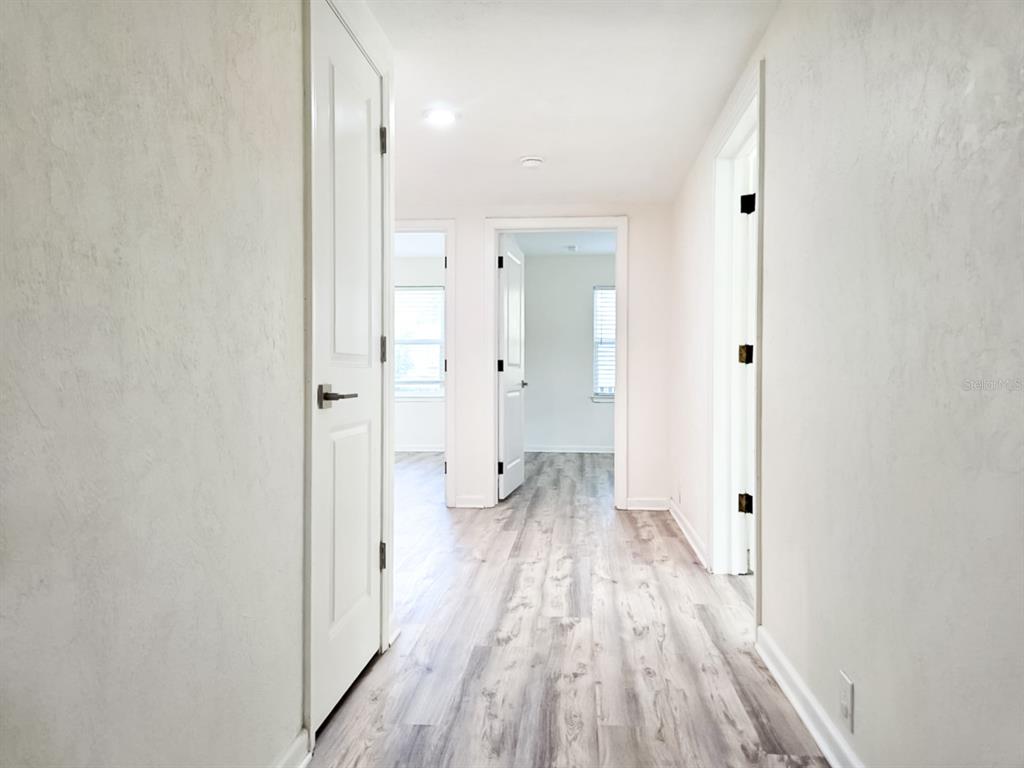 518 Northwest 27th Avenue Gainesville, FL 32609 - Photo 21 of 34 a view of a room with wooden floor and a bathroom
