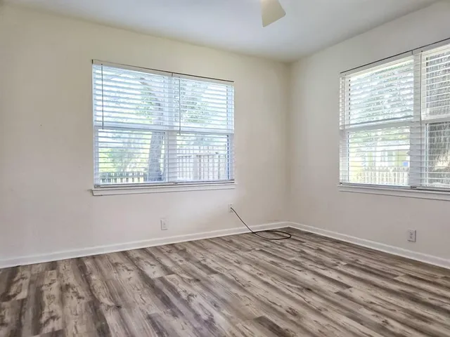 wooden floor in an empty room with a window