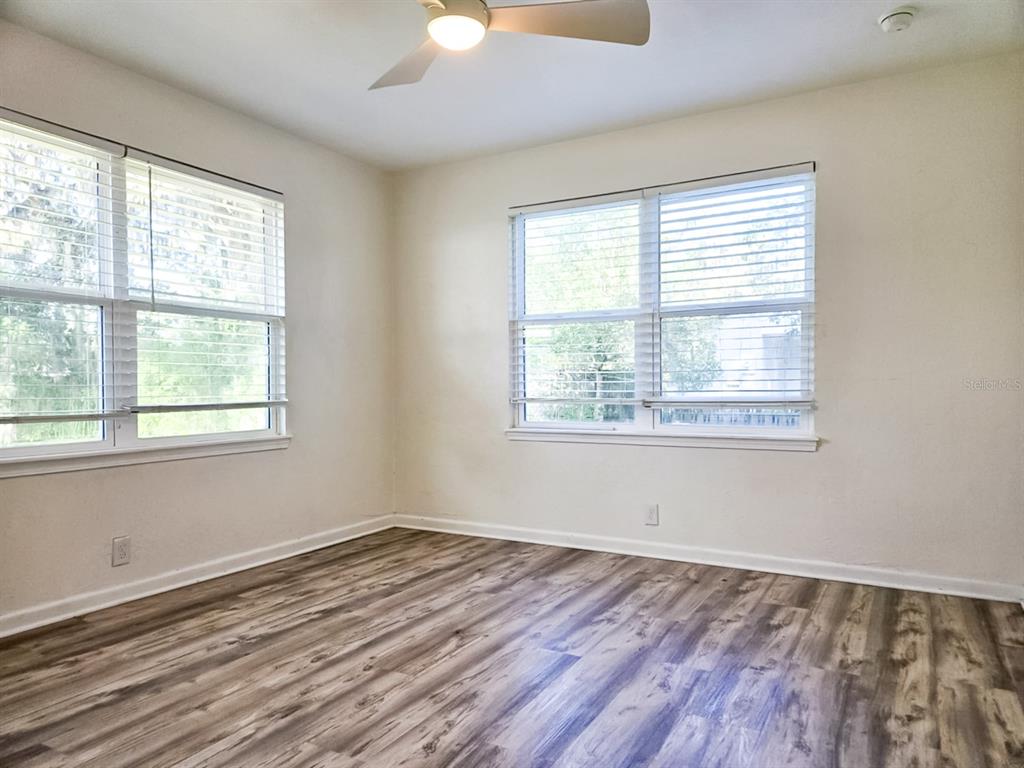 518 Northwest 27th Avenue Gainesville, FL 32609 - Photo 25 of 34 a view of an empty room with wooden floor and a window