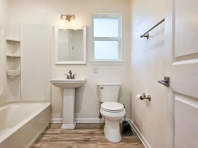 a bathroom with a sink a toilet and a bathtub