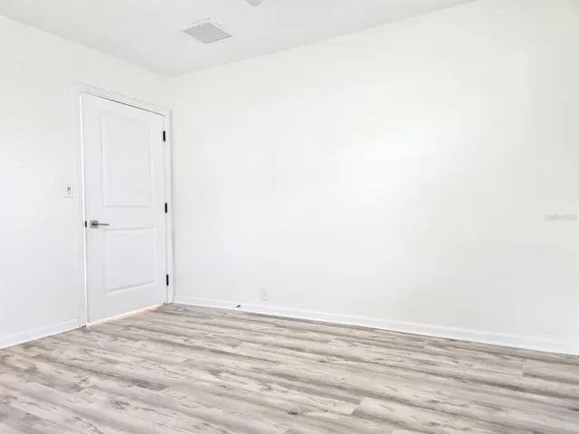 a view of a room with wooden floor