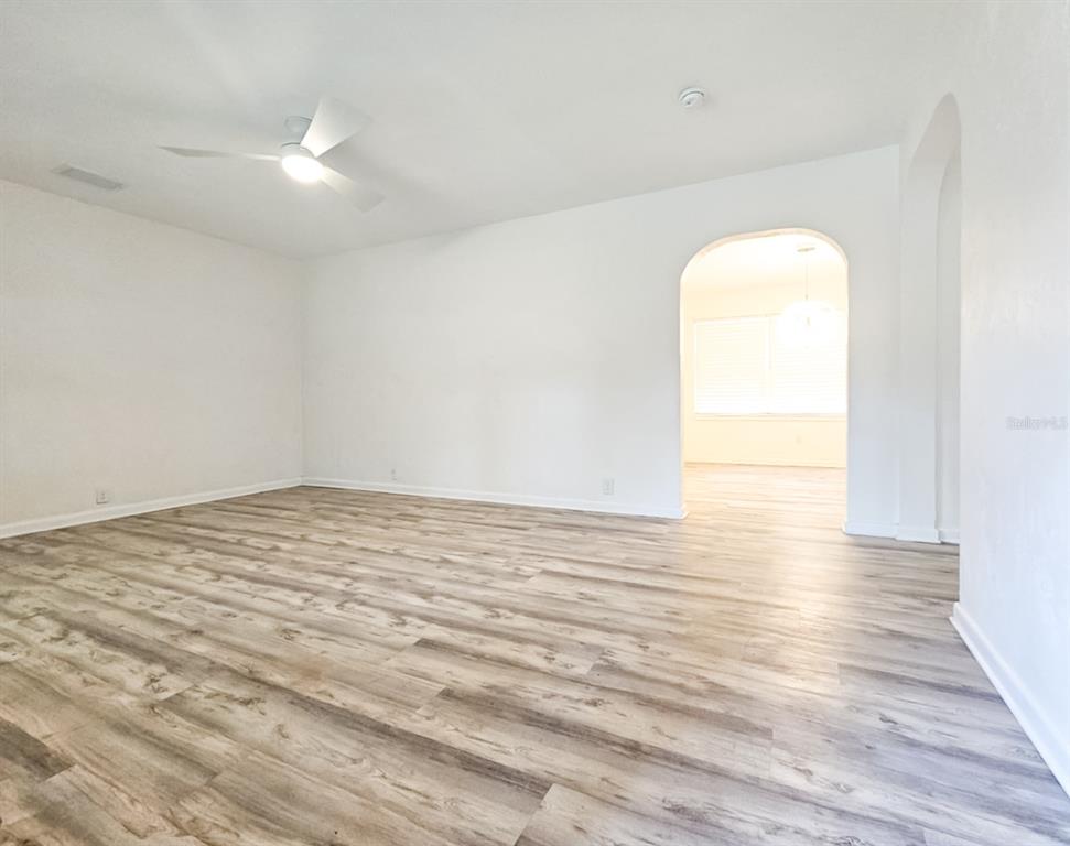 518 Northwest 27th Avenue Gainesville, FL 32609 - Photo 4 of 34 a view of a room with wooden floor and white walls