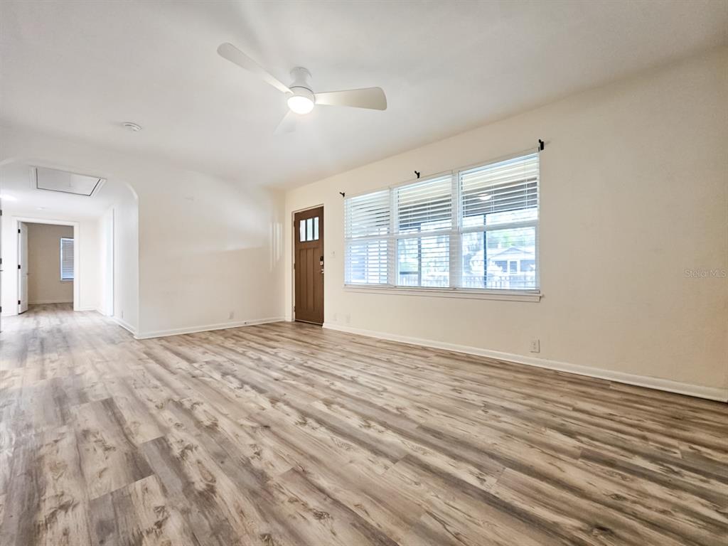 518 Northwest 27th Avenue Gainesville, FL 32609 - Photo 5 of 34 a view of empty room with wooden floor and fan