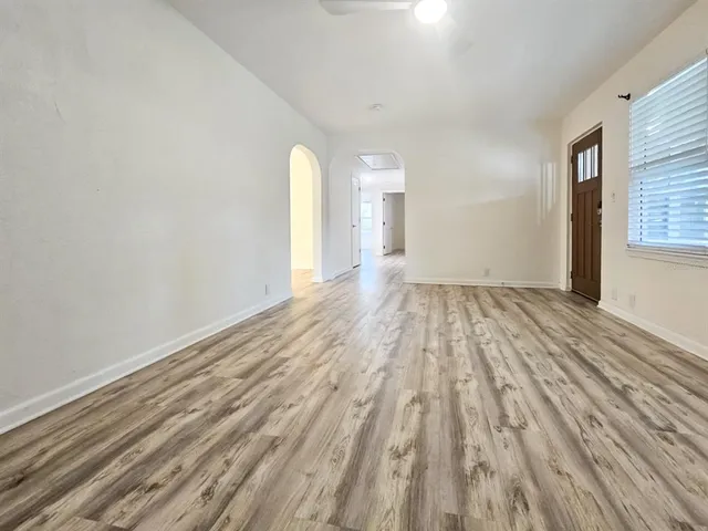 a view of a room with wooden floor and white walls