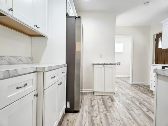 a kitchen with stainless steel appliances a stove microwave and refrigerator