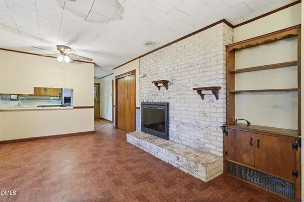 a view interior of a house with kitchen view and a fireplace