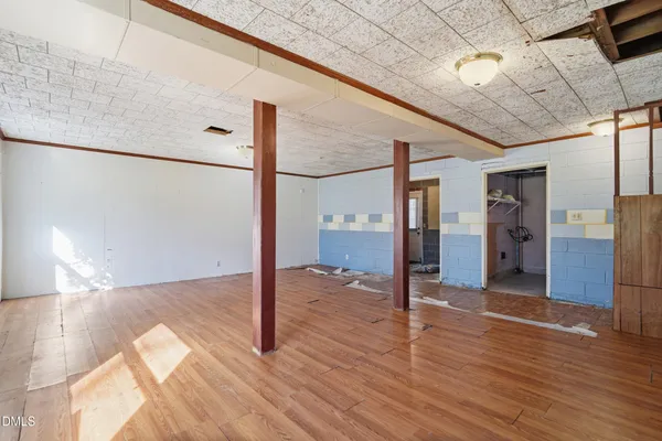 a view of a hallway with wooden floor