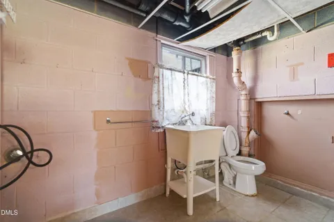 a bathroom with a granite countertop sink a toilet and a mirror
