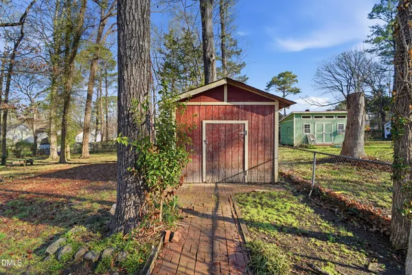 a backyard of a house with a yard and outdoor seating