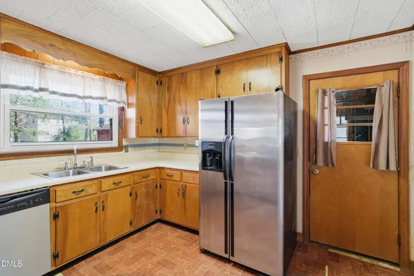 a kitchen with stainless steel appliances granite countertop a refrigerator and a sink