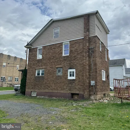a brick house with a yard