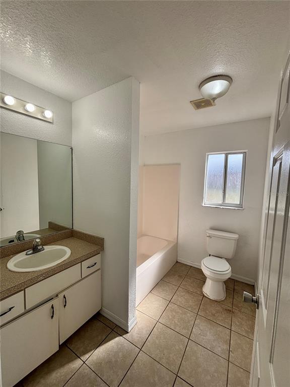 6 Spring Trail Ocala, FL 34472 - Photo 11 of 16 a bathroom with a granite countertop sink a toilet and a mirror