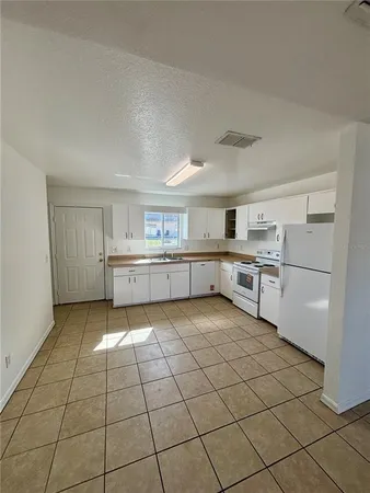 a view of a livingroom with an empty space and a more cabinets
