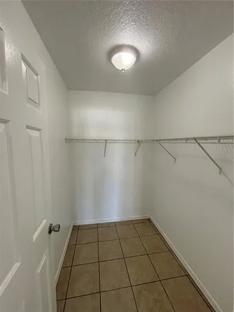 a kitchen with a sink window and cabinets
