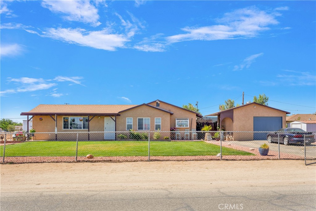 14743 Bonanza Road Victorville, CA 92392 - Photo 1 of 1 a front view of a house with a garden and pathway