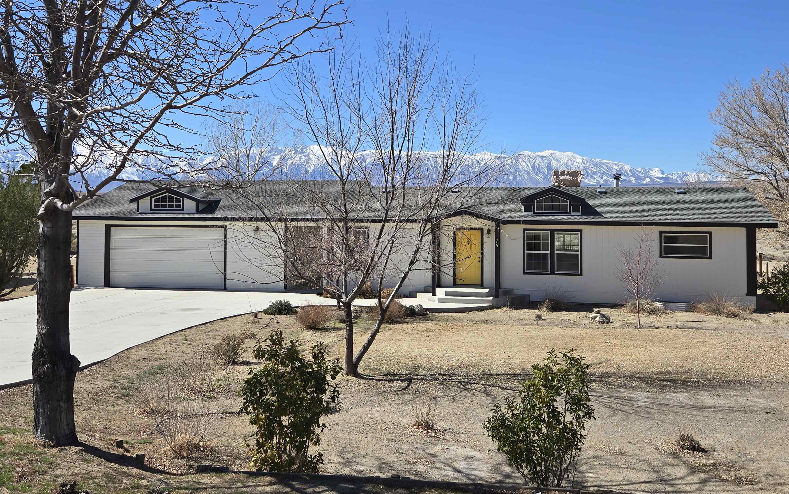 75 Sequoia Street Chalfant, CA 93514 - Photo 1 of 21 a front view of a house with a yard