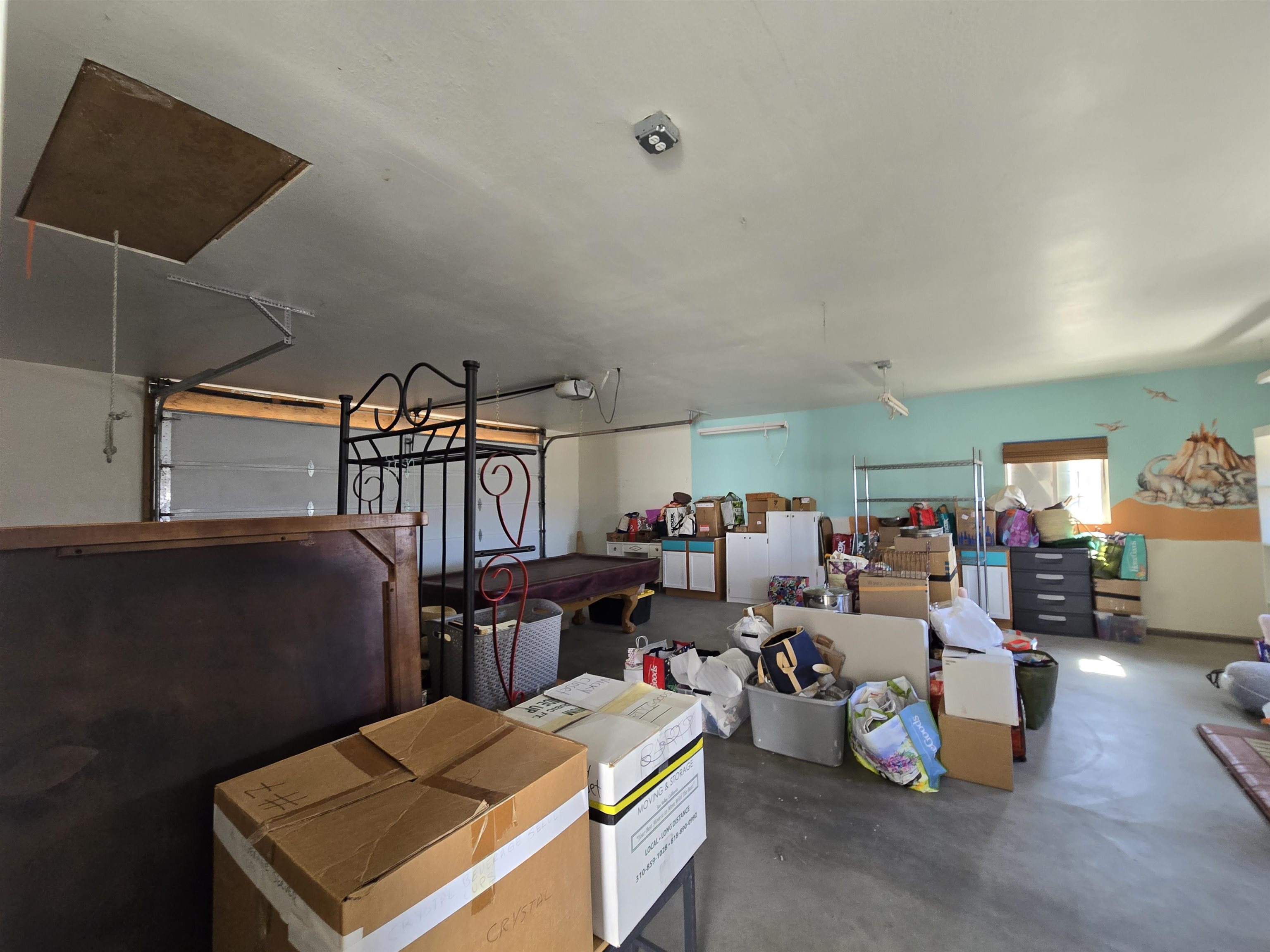 75 Sequoia Street Chalfant, CA 93514 - Photo 18 of 21 a living room with lots of furniture and clutter