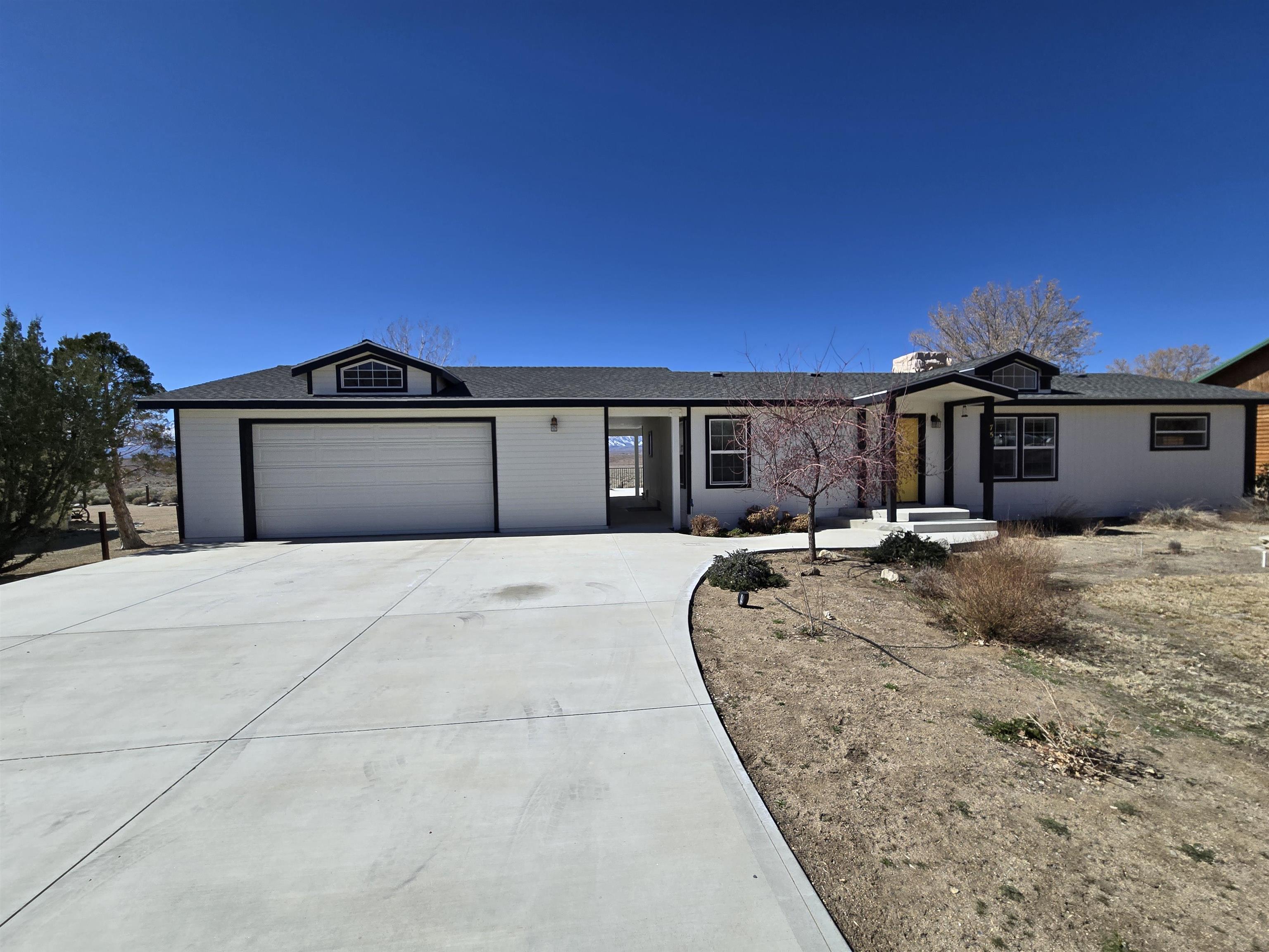 75 Sequoia Street Chalfant, CA 93514 - Photo 20 of 21 a front view of a house with a garden
