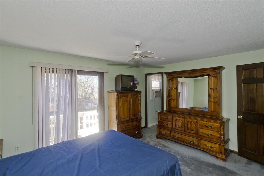 425 Miller Street Ludlow, MA 01056 - Photo 20 of 40 a bedroom with a bed and wooden floor