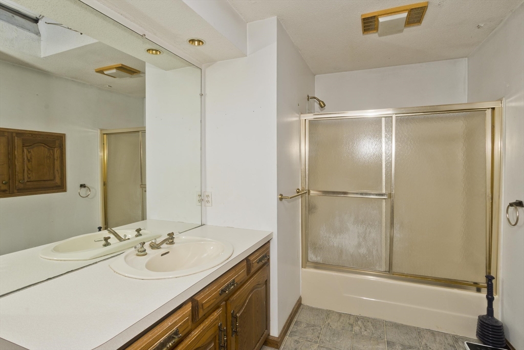 425 Miller Street Ludlow, MA 01056 - Photo 27 of 40 a bathroom with a double vanity sink mirror and shower