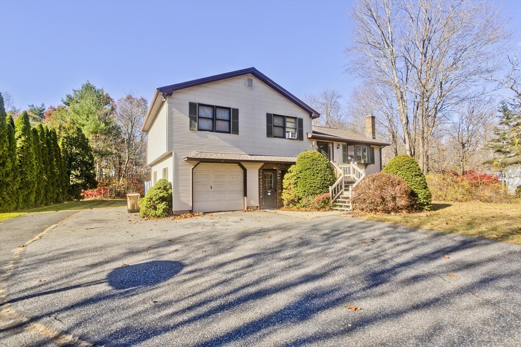 425 Miller Street Ludlow, MA 01056 - Photo 3 of 40 a front view of a house with garden