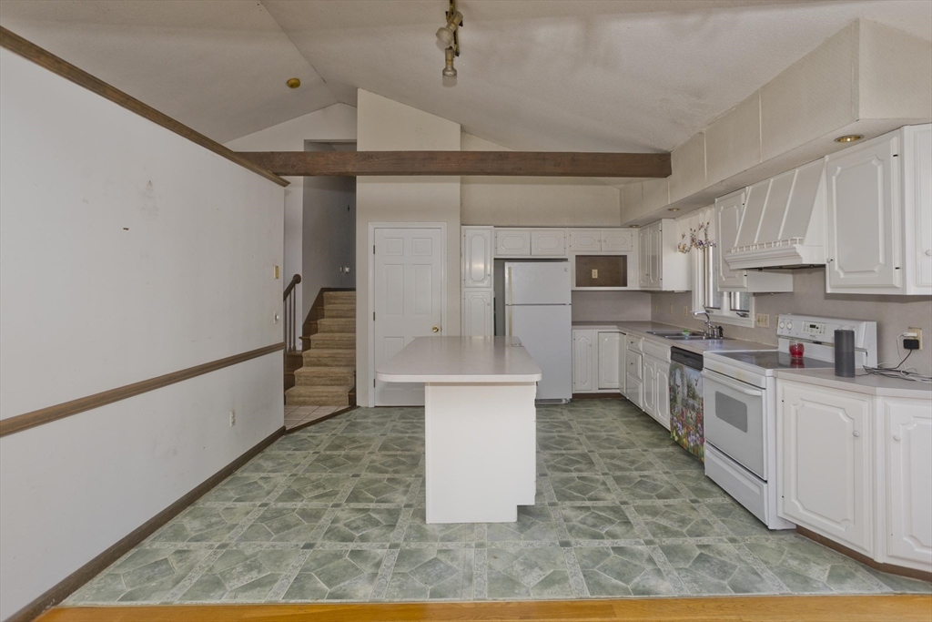 425 Miller Street Ludlow, MA 01056 - Photo 7 of 40 a kitchen with stainless steel appliances granite countertop a refrigerator a sink dishwasher a stove and white cabinets with wooden floor