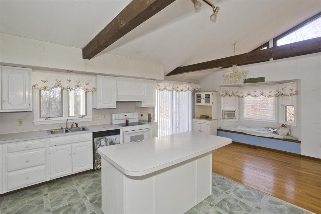 425 Miller Street Ludlow, MA 01056 - Photo 10 of 40 a large white kitchen with a sink and dishwasher a stove with wooden floor