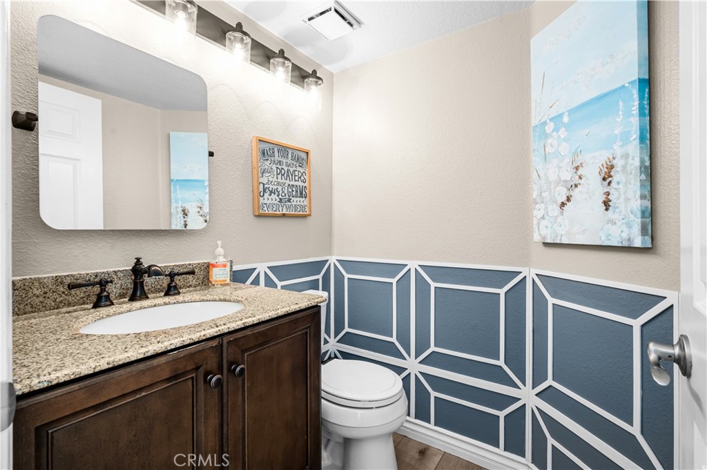 19465 Kinnow Lane Riverside, CA 92508 - Photo 20 of 61 a bathroom with a granite countertop toilet sink and mirror
