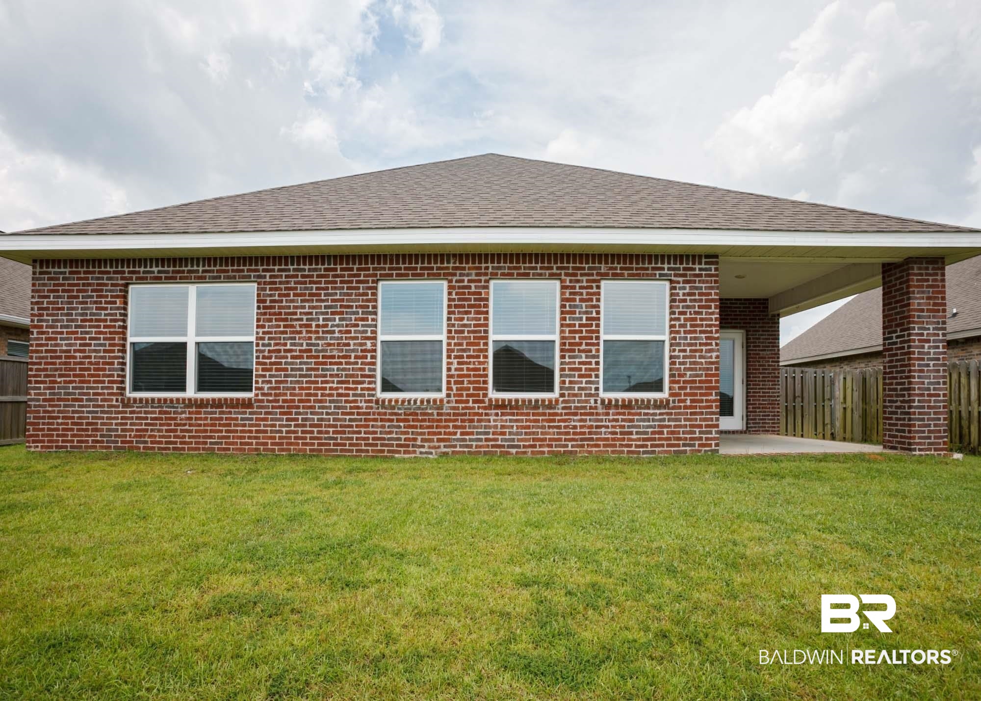 1436 Kairos Loop Foley, AL 36535 - Photo 5 of 52 Rear view of house with brick siding, roof with shingles, and a patio
