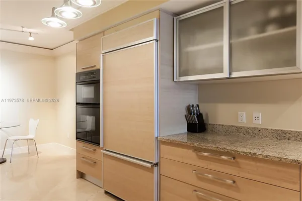 a kitchen with a refrigerator and cabinets
