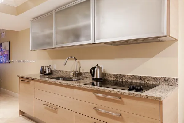 a view of a room with furniture and wooden floor