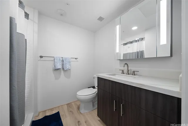 a bathroom with a sink toilet and a mirror