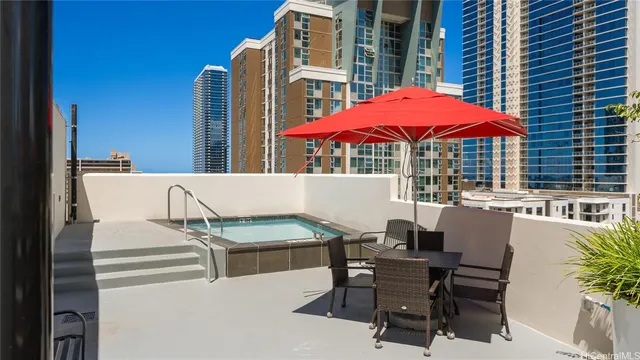 a view of a patio with a table and chairs under an umbrella