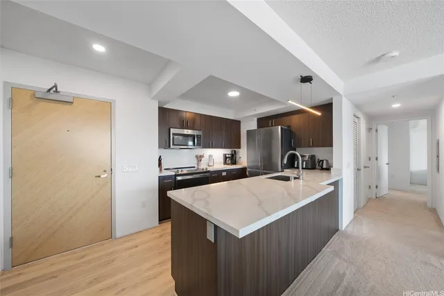 a kitchen with stainless steel appliances a refrigerator and a stove top oven