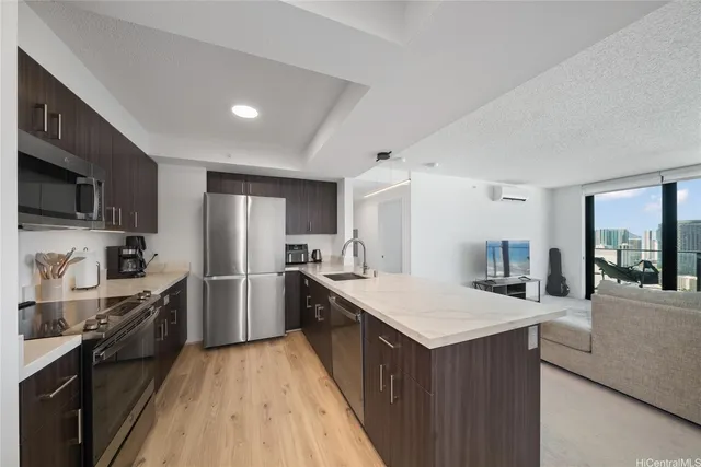 a kitchen with granite countertop a sink stove and refrigerator