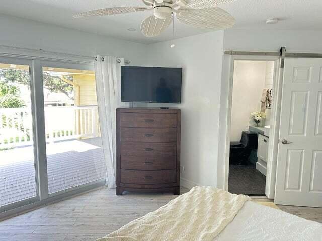 237 Seabreeze Circle Jupiter, FL 33477 - Photo 12 of 20 a bedroom with a bed and a flat tv screen