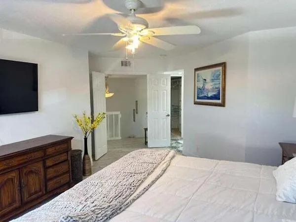 a bedroom with a bed and a flat screen tv