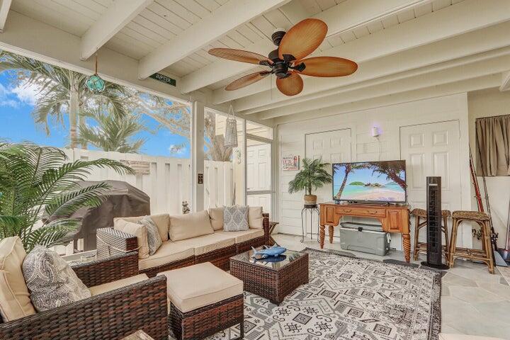 237 Seabreeze Circle Jupiter, FL 33477 - Photo 19 of 20 a living room with furniture a rug and a chandelier