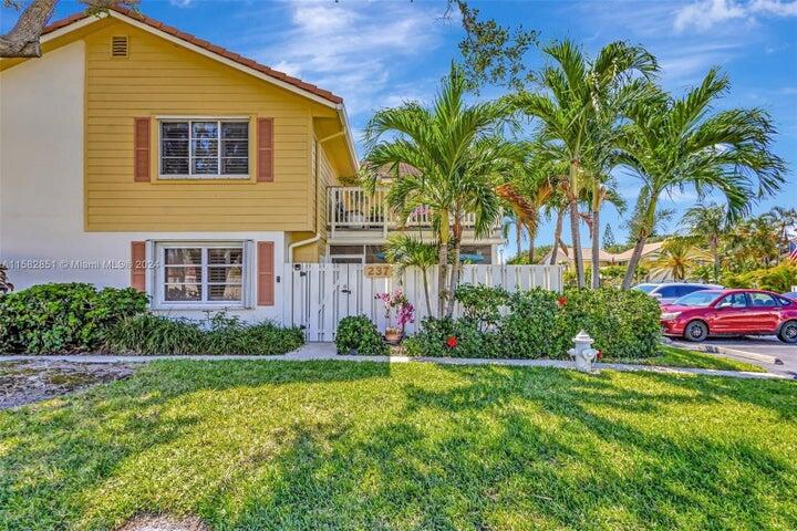 237 Seabreeze Circle Jupiter, FL 33477 - Photo 2 of 20 a front view of house with yard and green space