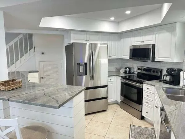 a kitchen with stainless steel appliances granite countertop a stove and a refrigerator