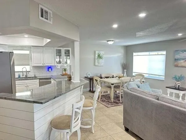 a kitchen with stainless steel appliances kitchen island granite countertop a sink and cabinets
