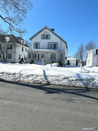 a large house with a large tree in front of it