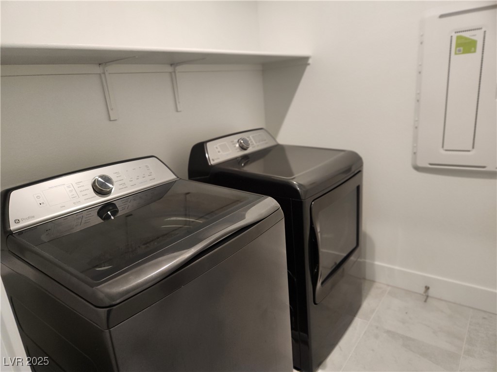 3197 Bertonico Street Henderson, NV 89044 - Photo 15 of 30 Laundry room with light tile patterned floors, independent washer and dryer, and electric panel