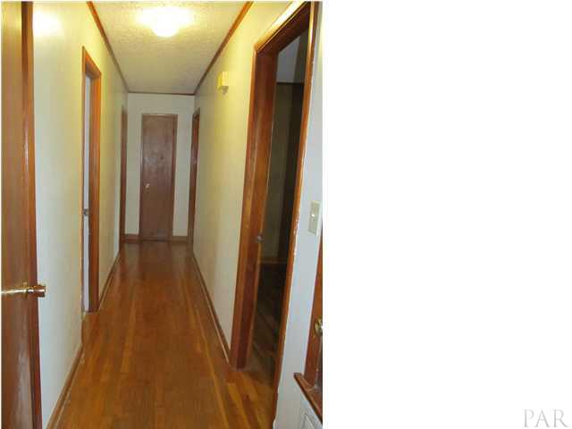 6084 St Alban Road Pensacola, FL 32503 - Photo 15 of 18 A view of the beautiful hardwood floors down the hallway!