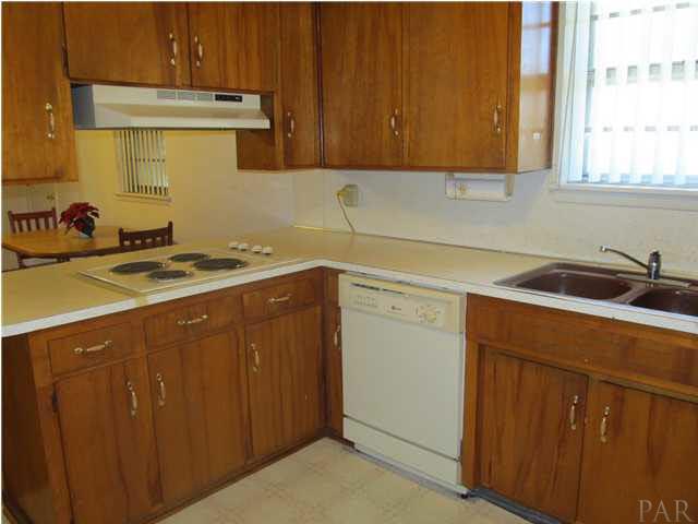6084 St Alban Road Pensacola, FL 32503 - Photo 7 of 18 The kitchen has real wood cabinets, and a window over the sink for natural lighting!