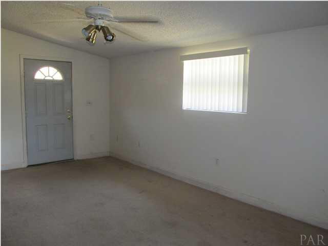 6084 St Alban Road Pensacola, FL 32503 - Photo 9 of 18 The family room/bonus room has two windows, a door to the backyard, and is carpeted.