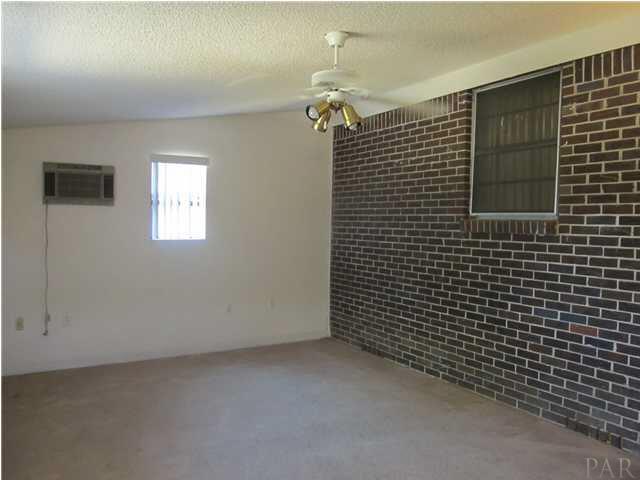 6084 St Alban Road Pensacola, FL 32503 - Photo 10 of 18 Another view of the family room/bonus room, with a wall air conditioning unit.